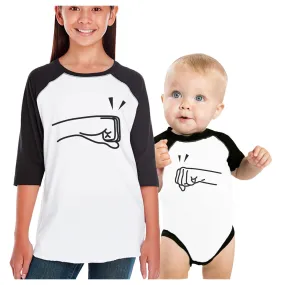 Fists Pound Kid and Baby Matching Black And White Baseball Shirts